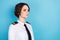 Photo of charming brunette young woman look empty space professional aircraft pilot isolated on blue color background