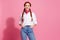 Photo of charming cheerful adorable girl wear trendy clothes put arms in pockets isolated on pink color background