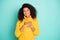 Photo of charming dark skin wavy lady holding hands on chest eyes closed inner harmony wear yellow knitted pullover