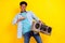 Photo of charming funny dark skin guy dressed denim shirt smiling singing dancing listening boom box isolated yellow