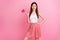 Photo of charming funny lady hold big heart shape lollipop on stick good mood nice day wear white singlet dotted short
