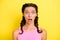 Photo of charming impressed young woman pigtails wear tank top big eyes open mouth isolated yellow color background