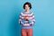 Photo of charming lady hold telephone smile look screen wear colorful striped sweater red trousers isolated blue color