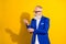 Photo of charming luxurious old man fix sleeve wear glasses blue jacket isolated on yellow color background