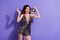 Photo of charming model lady hold glowing disco ball celebrate birthday night club wear overall shorts isolated purple