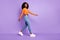 Photo of charming sweet dark skin woman dressed orange walking isolated purple color background