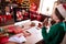 Photo of charming sweet young woman dressed green sweater talking modern gadget drinking wine waving arm indoors house