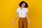 Photo of charming unsure lady girl wear stylish clothes have question shrugging shoulders isolated on yellow color