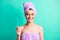 Photo of charming young girl hold toothbrush beaming smile wear purple towel turban isolated turquoise color background