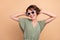 Photo of charming young joyful woman free time dance wear sunglass cool isolated on beige color background