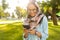 Photo of cheerful arabian woman wearing headscarf using mobile phone