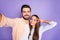 Photo of cheerful brunette man and woman make v-sign take selfie lovers isolated on violet color background