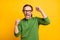 Photo of cheerful champion guy raise fists open mouth scream wear eyeglasses green pullover isolated yellow color