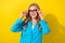 Photo of cheerful classy gorgeous girl beaming smile hands touch glasses isolated on yellow color background