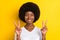 Photo of cheerful cool dark skin young woman make v-signs smile good mood isolated on yellow color background