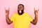 Photo of cheerful crazy afro american man make fingers horned sign rock music isolated on pink color background