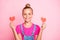 Photo of cheerful cute nice schoolgirl holding two red heart shapes with hands wearing fuchsia t-shirt isolated over