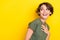 Photo of cheerful ecstatic girl with bob hairstyle wear khaki t-shirt look empty space hand on chest isolated on yellow