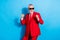 Photo of cheerful glad nice retired man dance enjoy disco wear sunglass red tuxedo isolated blue color background