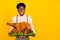 Photo of cheerful guy hold dish baked turkey look empty space wear specs suspenders shirt isolated yellow color
