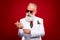 Photo of cheerful happy old man fix sleeves wear sunglass smile entertainer isolated on red color background