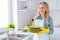 Photo of cheerful housewife blond lady hold clean plates stack good mood finish fast service spring cleaning worker
