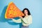 Photo of cheerful hungry lady hands hold big paper pizza collage beaming smile isolated on blue color background