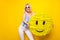 Photo of cheerful nice blond short hair lady hold pinata wear spectacles top pants isolated on yellow color background