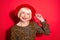 Photo of cheerful nice lovely old woman hold hand wear hat smile good mood lady isolated on red color background