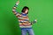 Photo of cheerful nice positive young woman dance point finger funky mood isolated on green color background