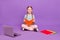 Photo of cheerful positive learner girl sit floor read book toothy smile wear blue shirt isolated purple color