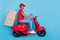 Photo of cheerful pretty short hair person dressed red uniform moto rider delivering pizzas stack isolated blue color