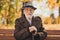 Photo of cheerful retired old grey haired grandpa street central park sit bench positive emotions enjoy sunny day