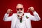 Photo of cheerful retired old positive man hold hands christmas trree balls beard smile isolated on red color background