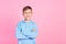 Photo of cheerful schoolkid toothy smile crossed arms posing empty space isolated on pink color background