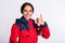 Photo of cheerful shiny young ambulance woman wear red jacket smiling showing thumb up isolated white color background