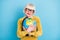 Photo of cheerful short hairdo aged lady hug globe wear eyewear blouse isolated on blue color background