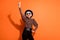 Photo of cheerful smiling crazy happy positive old woman dance point finger copyspace isolated on orange color