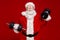 Photo of cheerful strong retired man wear santa claus costume spectacles rising heavy dumbbells isolated red color