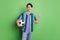 Photo of cheerful young happy positive man hold hands football winner team isolated on green color background