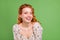 Photo of cheerful young joyful woman smile joke funny good mood face isolated on green color background