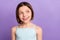 Photo of cheerful young positive little girl look empty space dream good mood isolated on purple color background