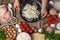 In the photo, the chef is preparing a risotto. In the frame, a cook is stirring rice in a saucepan. Bright ingredients are spread