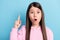 Photo of childish impressed schoolgirl dressed pink outfit pointing finger empty space copyspace isolated blue color