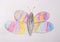 Photo of children`s drawing. Butterfly painted with colored pencils.