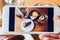 Photo of chocolate cake, cappucino, eyeglass, seasoning and peach tea through smartphone