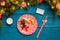 Photo of Christmas branches of pine, sushi sticks, prediction cookies, plates with red pattern