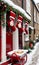 Photo Of Christmas Stockings Hanging From A Sleigh Filled With Mince Pies In A Snowy Alleywa. Generative AI