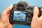 Photo of church and sea on camera display during the summer vacation. Travel photography