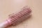 Photo close up top view hair fall at white pink plastick comb at wooden table